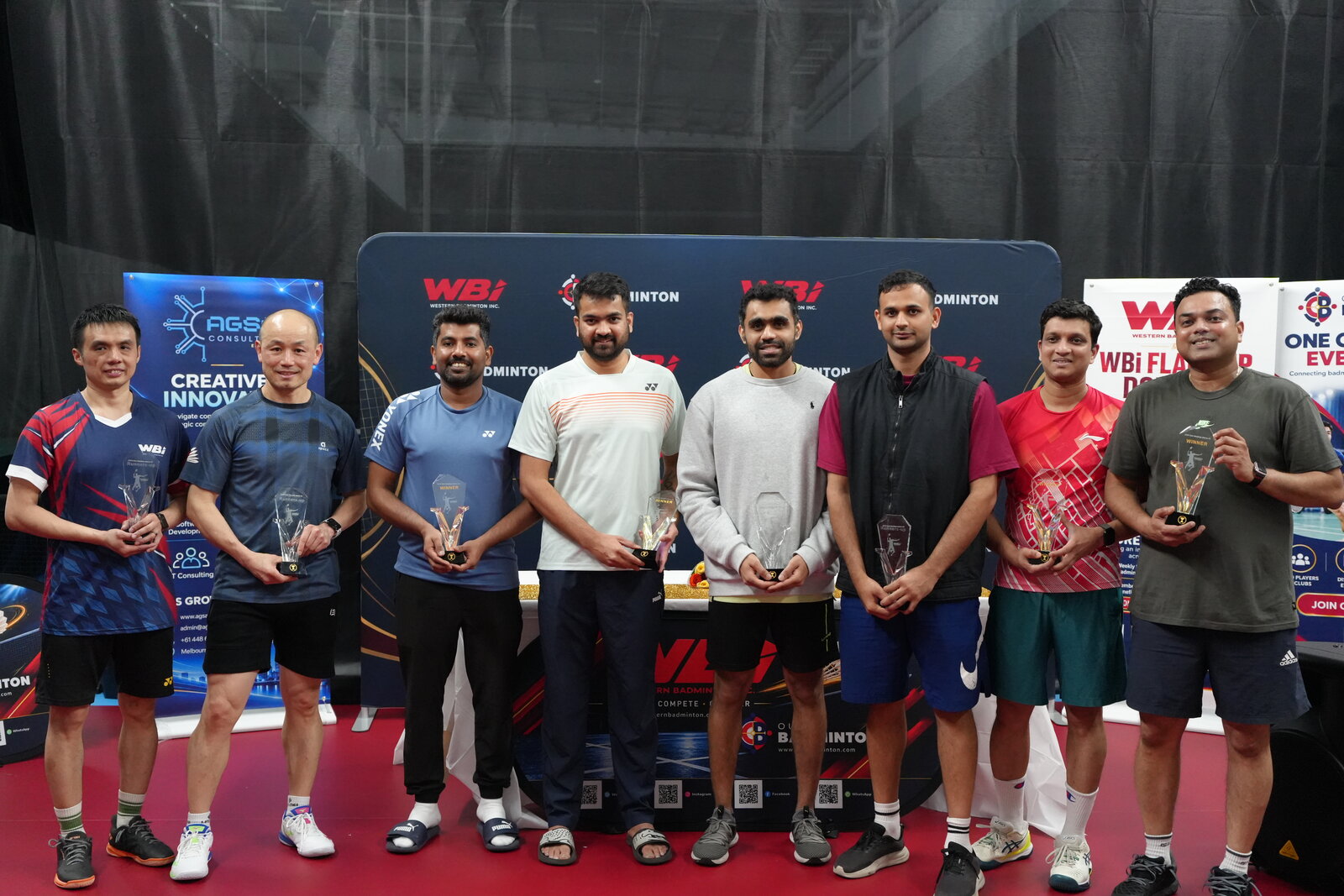 Men’s Doubles Above 40 and Below 40 winners and runners-up celebrating together with their trophies