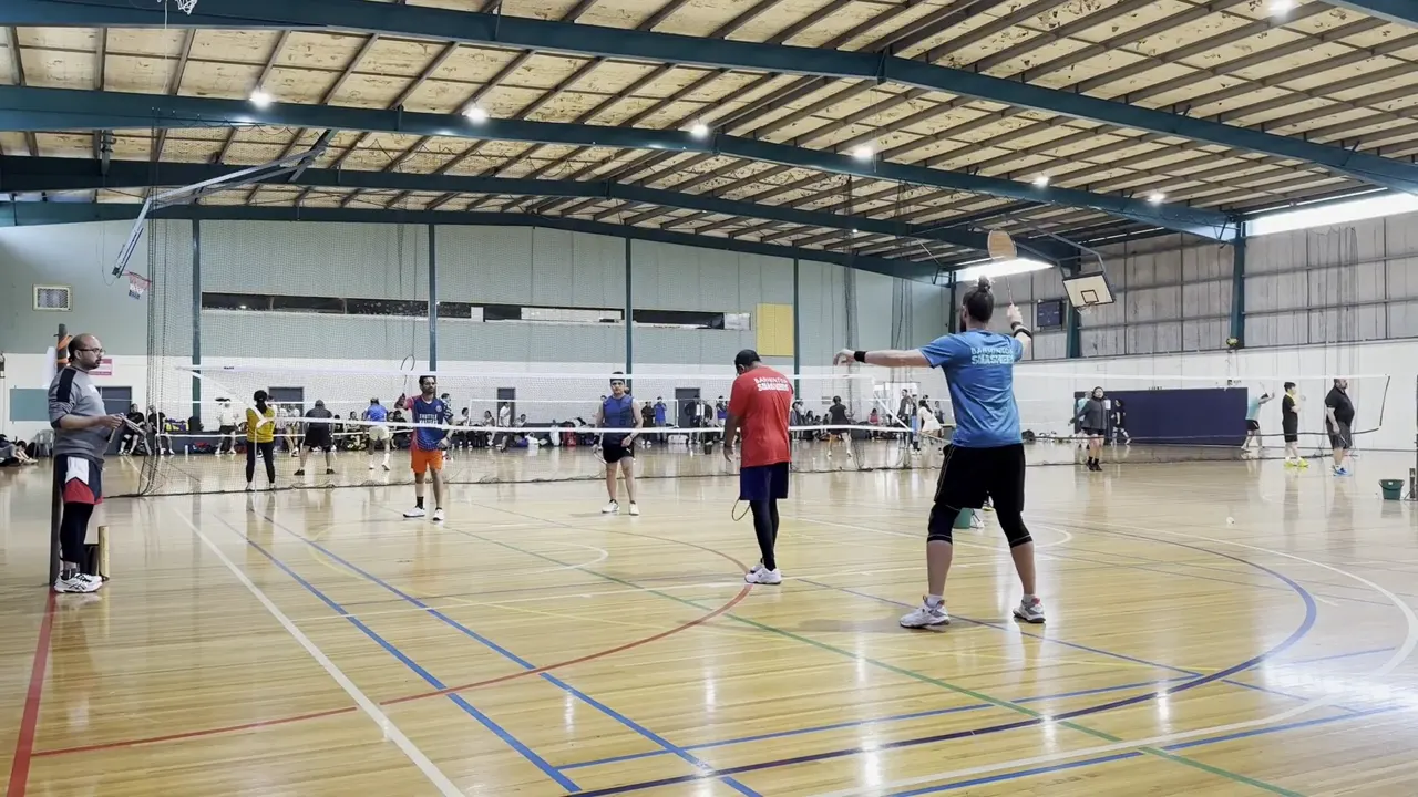 At 1.2 seconds, the near-side blue-shirted player prepares an overhead while the red-shirted partner stands ahead and left.