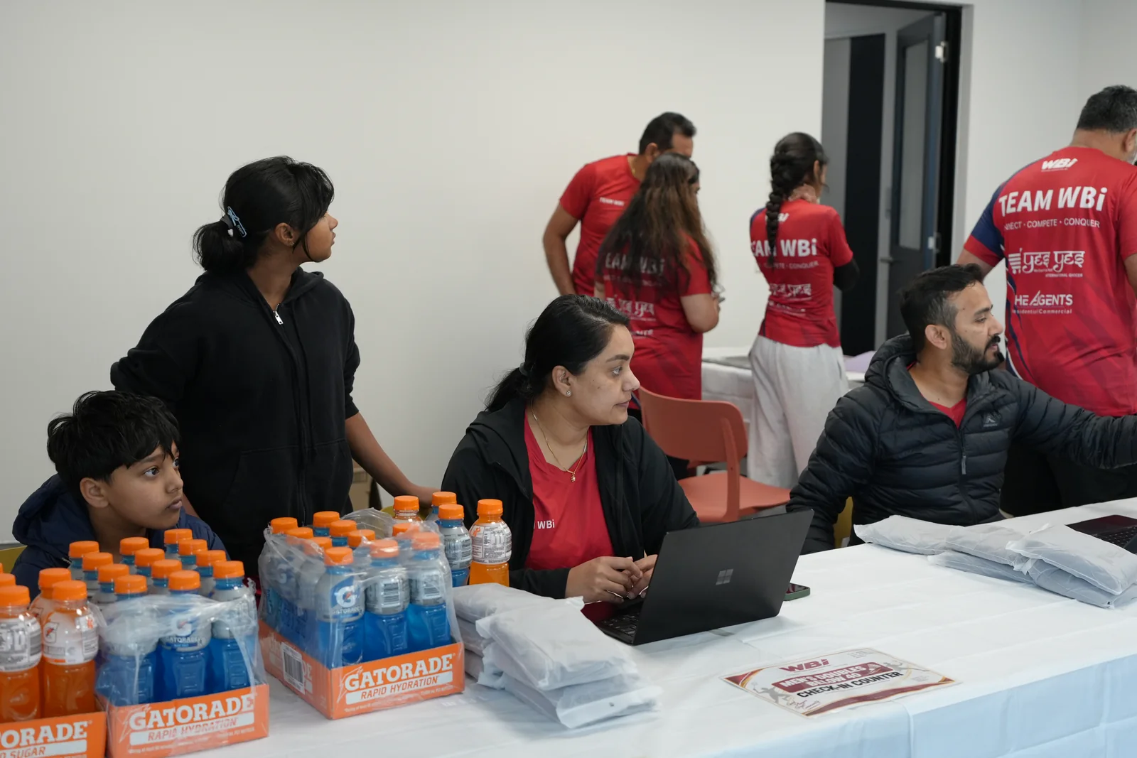 Volunteers at the registration desk with laptops and supplies