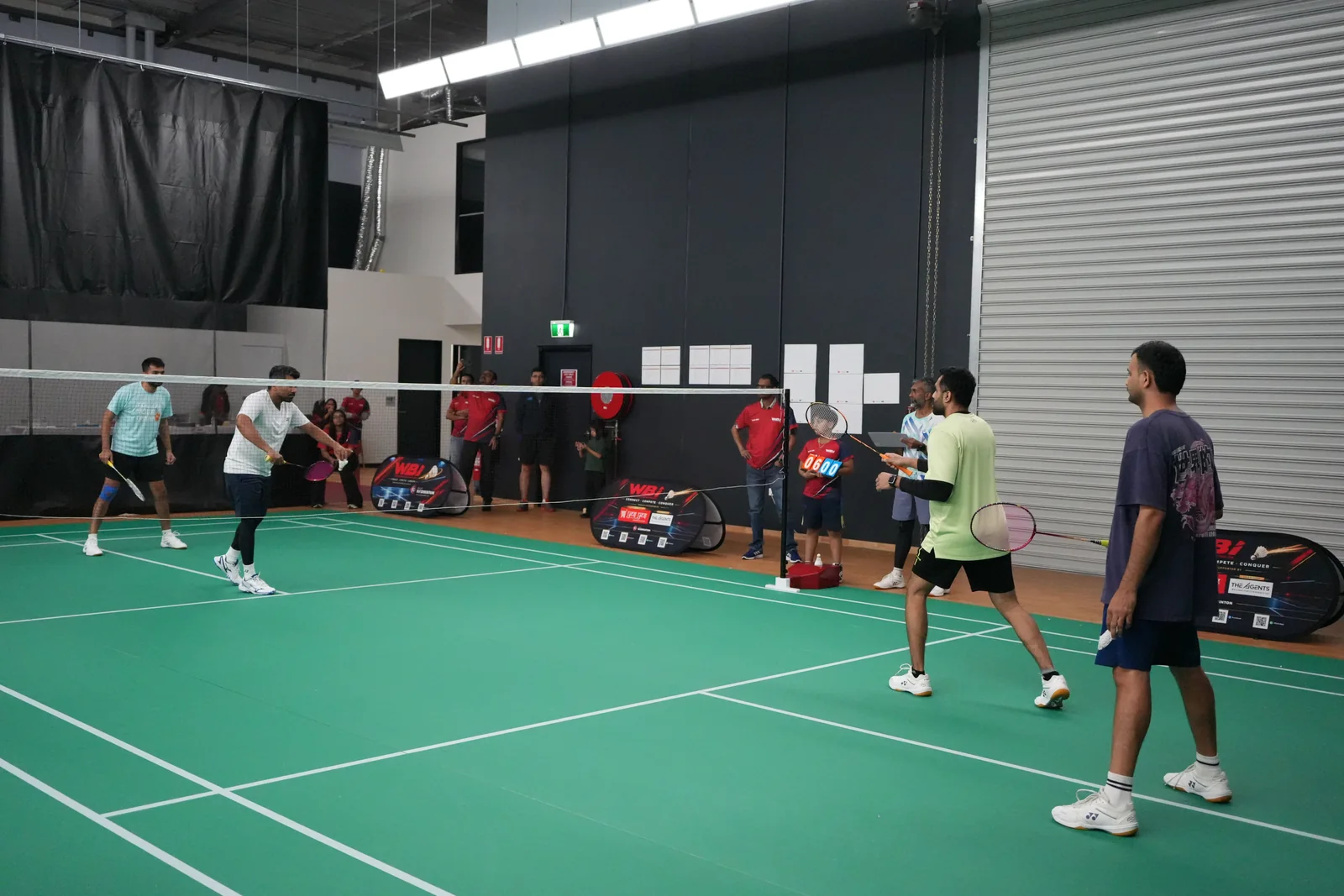 Tournament play taking place alongside the courtside organising team